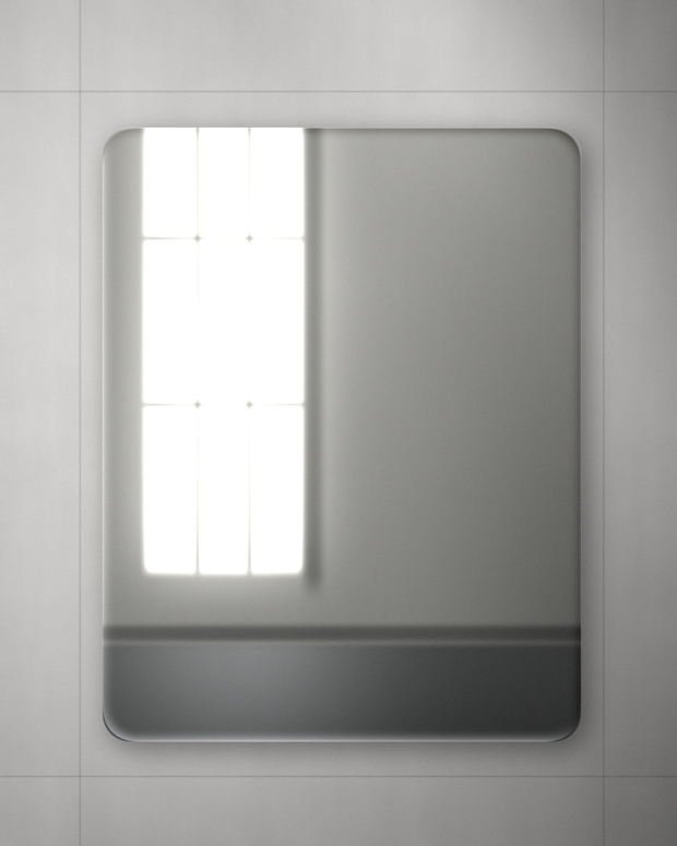 A soft-cornered mirror set out on a wall between pencilled fixing lines, its wide bevel drawing a bright frame around the reflection.